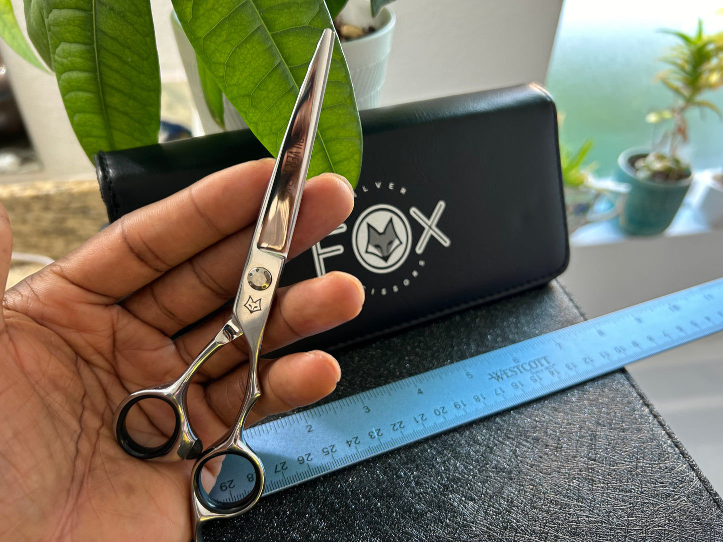 Scissors resting against palm of hand.