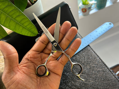 Scissors resting against palm of hand.