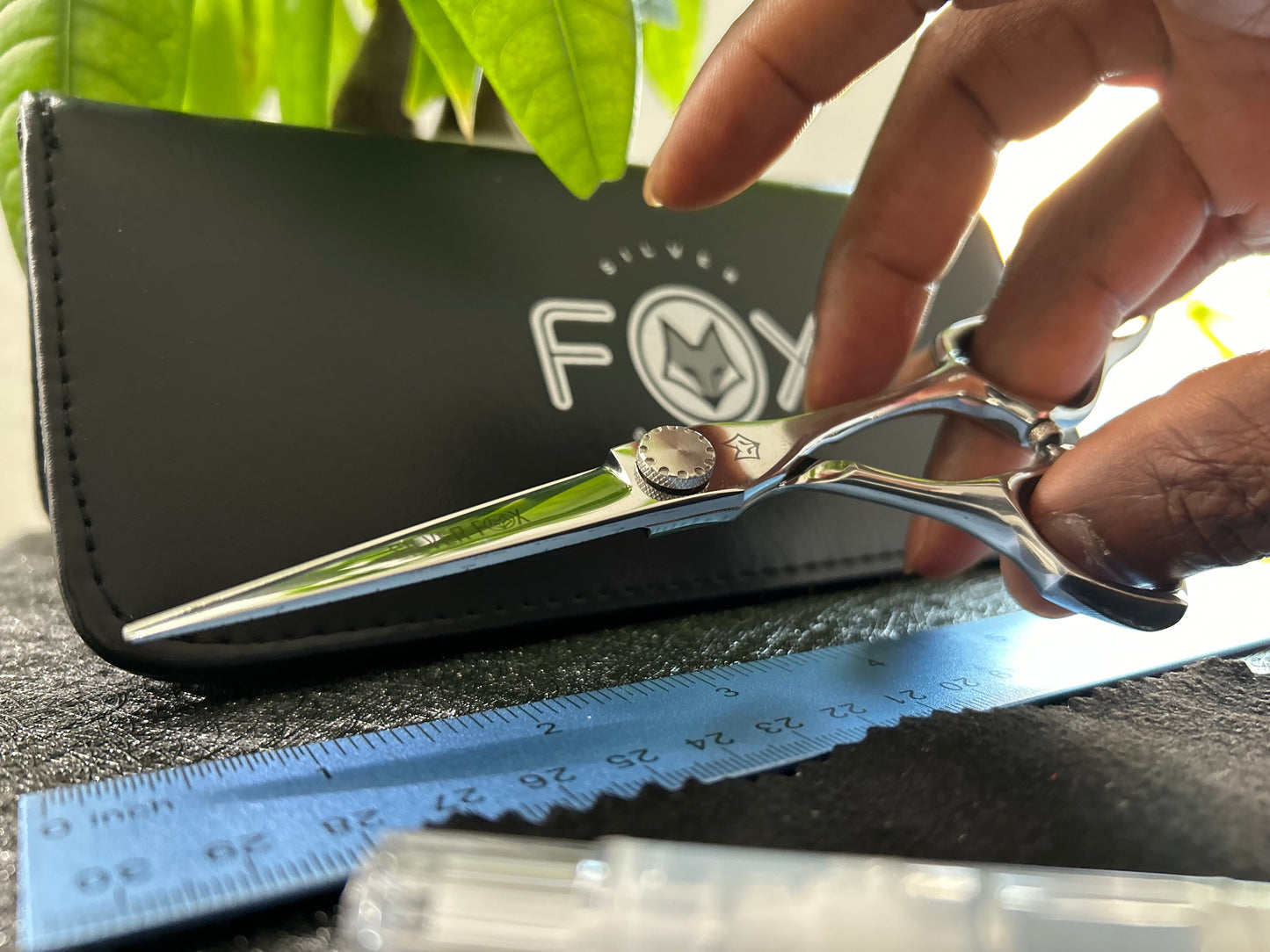 Scissors held with fingers threaded through rings.