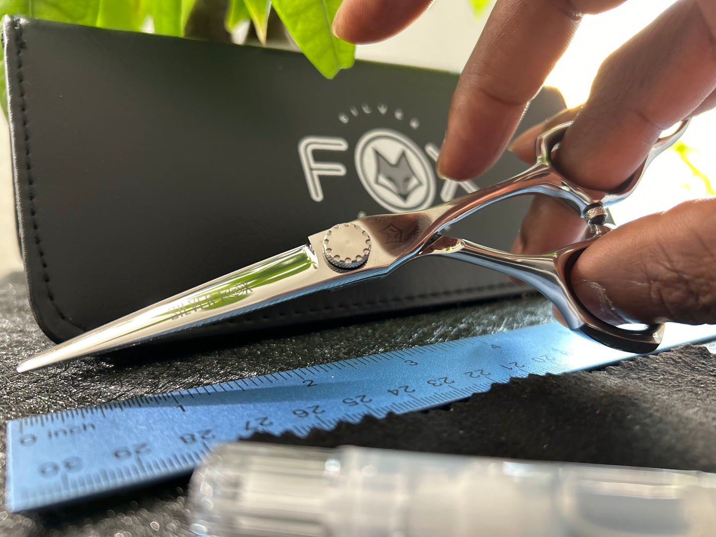 Scissors held with fingers threaded through rings.