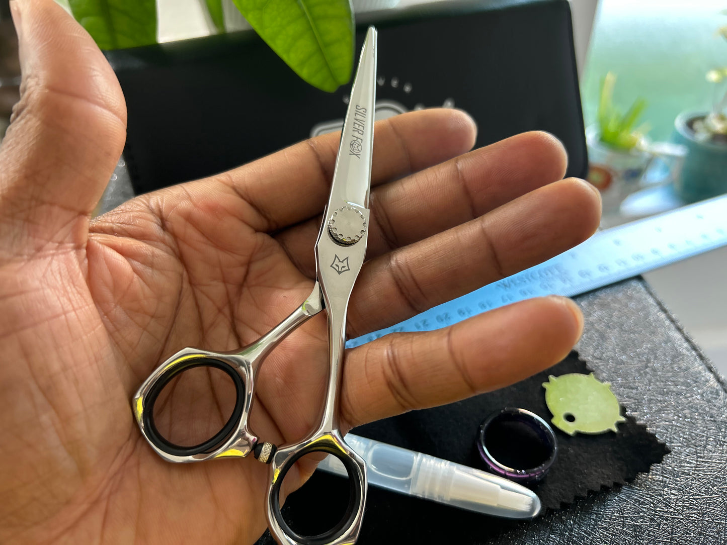 Scissors resting against palm of hand.