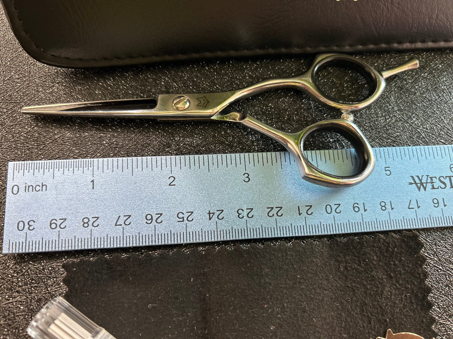 Top view of scissors next to ruler for scale.