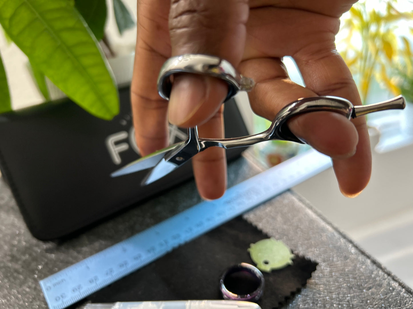 Scissors held with fingers threaded through rings.