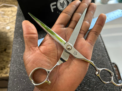 Scissors resting against palm of hand.