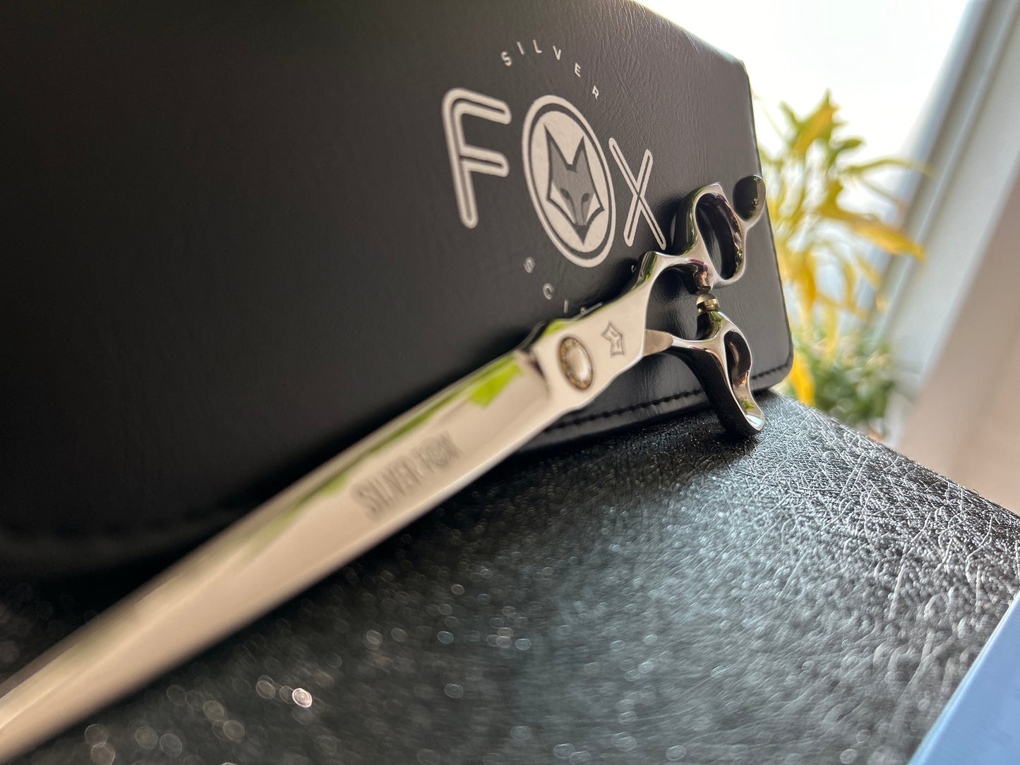 Scissors resting against black case.