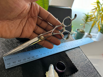 Scissors held in hand.