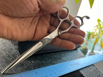 Scissors held in hand.