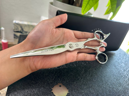 Scissors held in palm of hand.