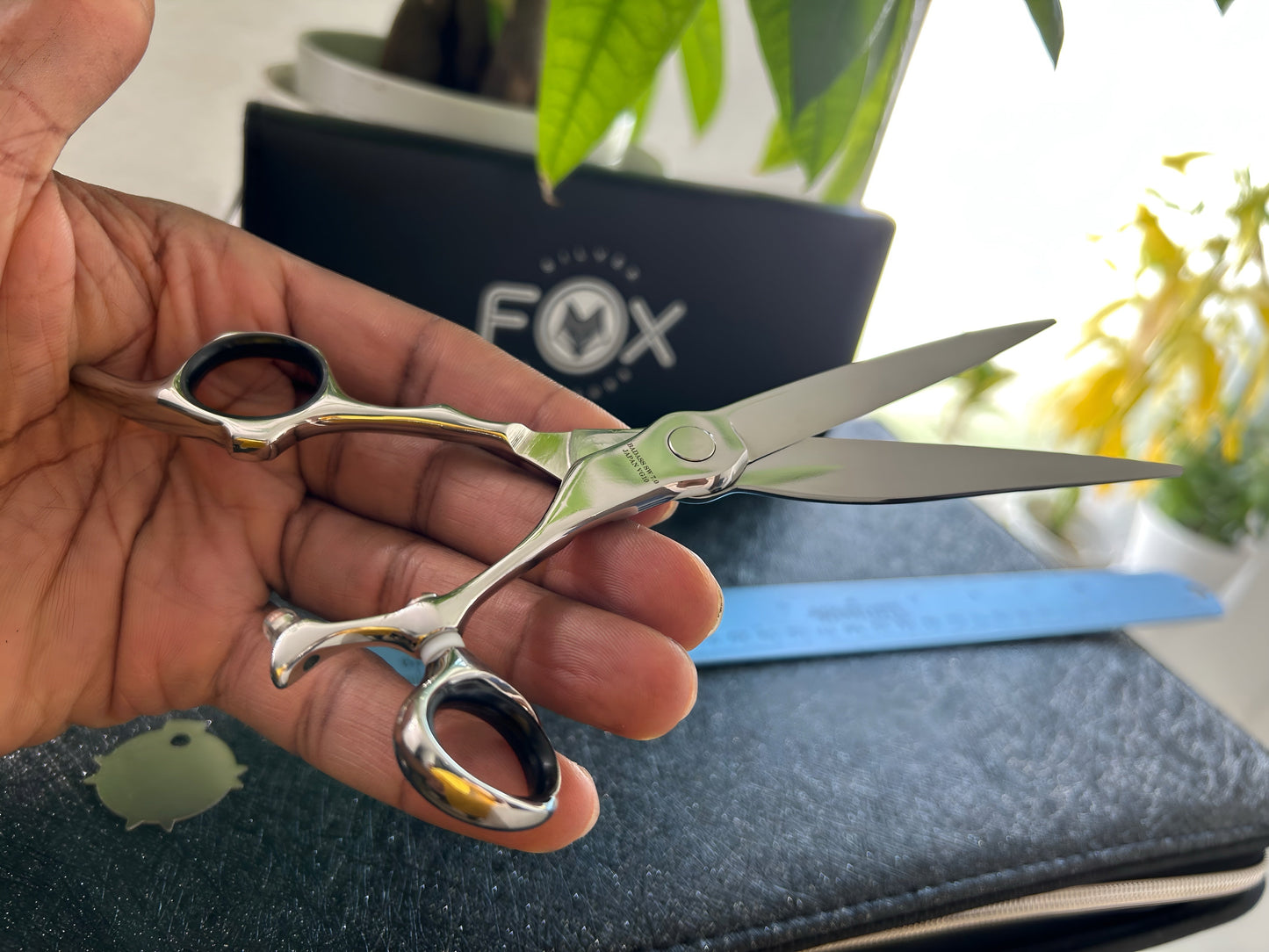 Scissors held in palm of hand.