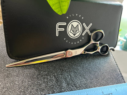 Scissors resting against black case.