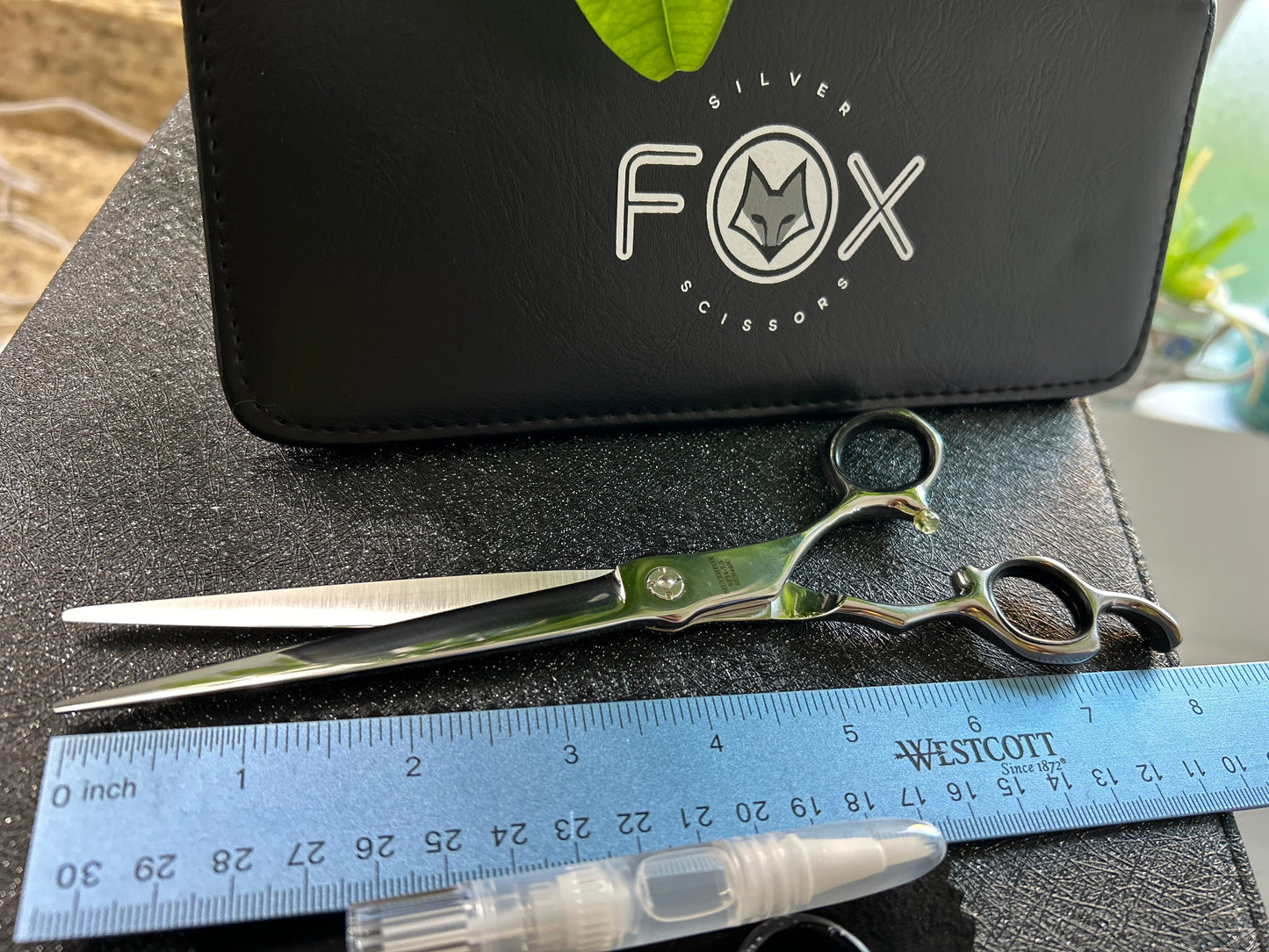 Top view of scissors next to ruler for scale.