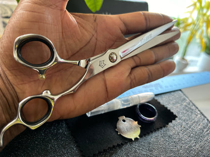 Scissors resting against palm of hand.