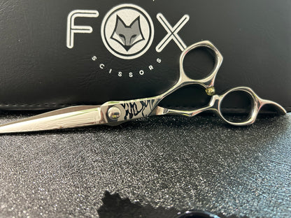 Scissors resting against black case.