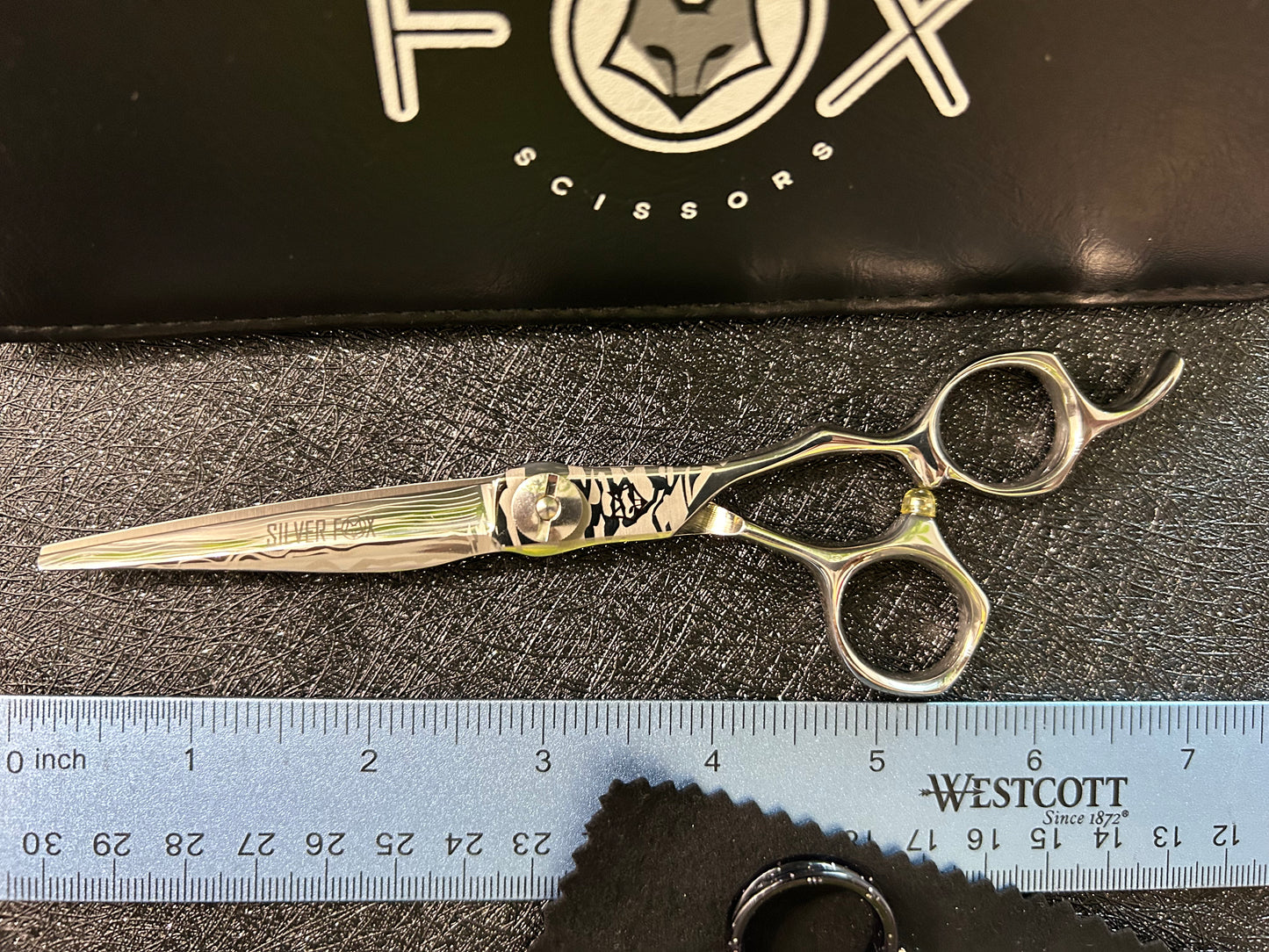 Top view of scissors next to ruler for scale.