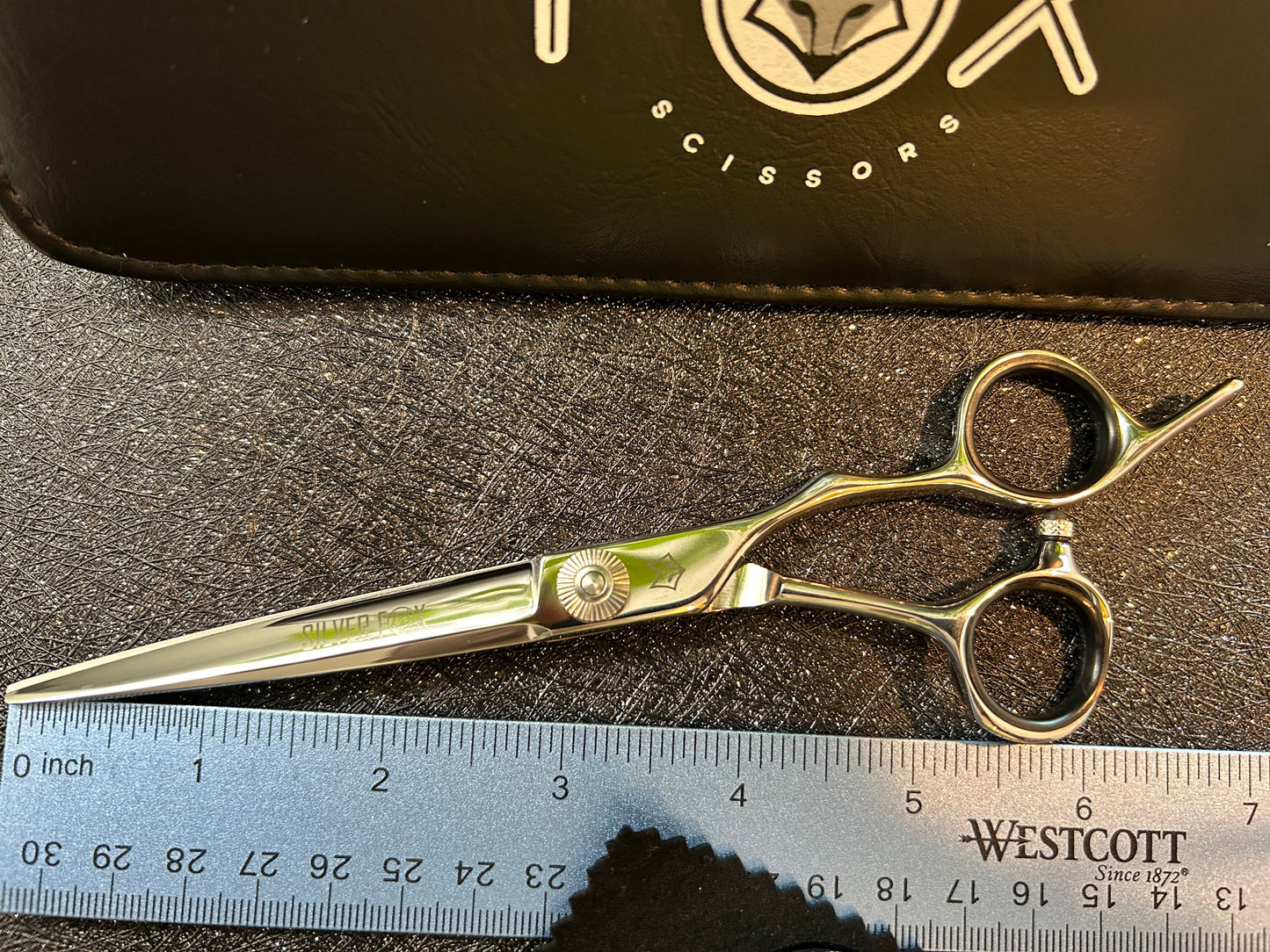 Top view of scissors next to ruler for scale.