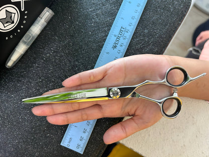 Scissors held in palm of hand.