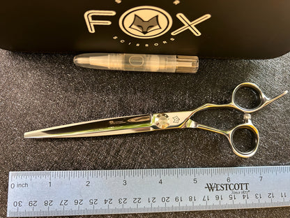 Top view of scissors with ruler for scale.