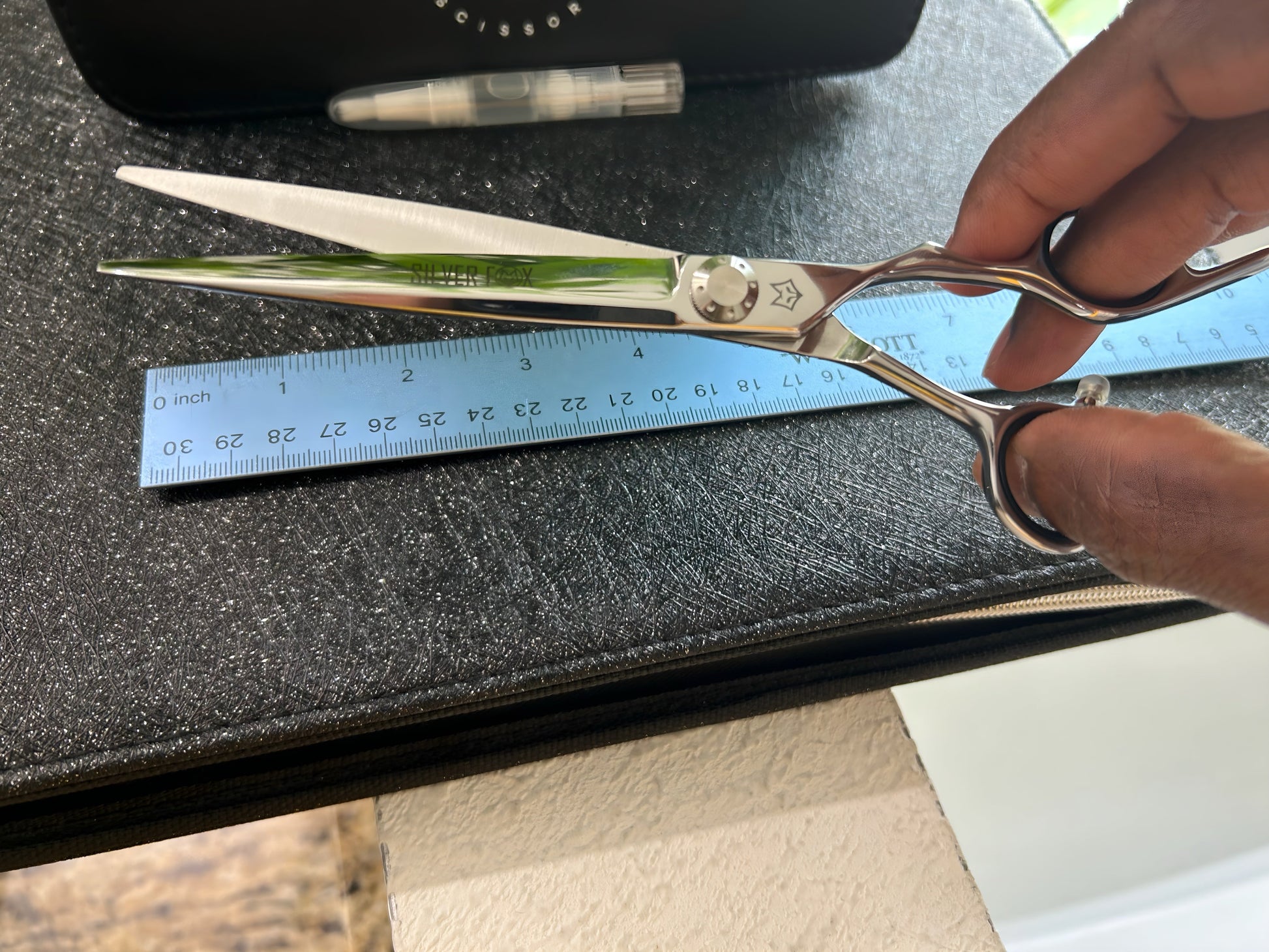 Scissors held with fingers threaded through rings.