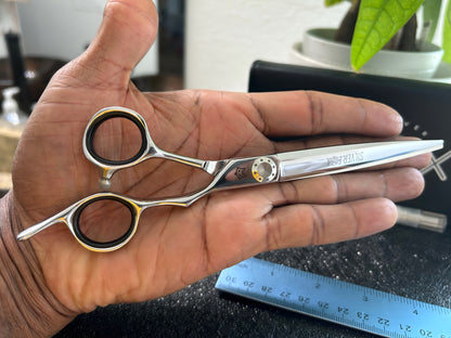 Scissors held in palm of hand.