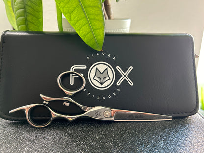 Scissors resting against black case.