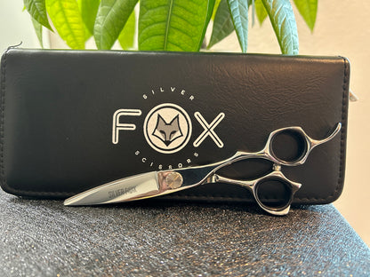 Scissors resting against black case.