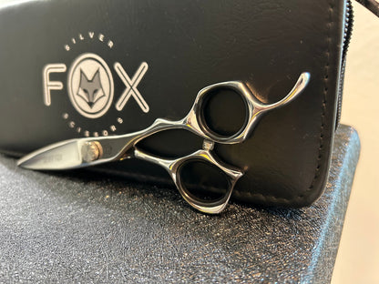 Scissors resting against black case.