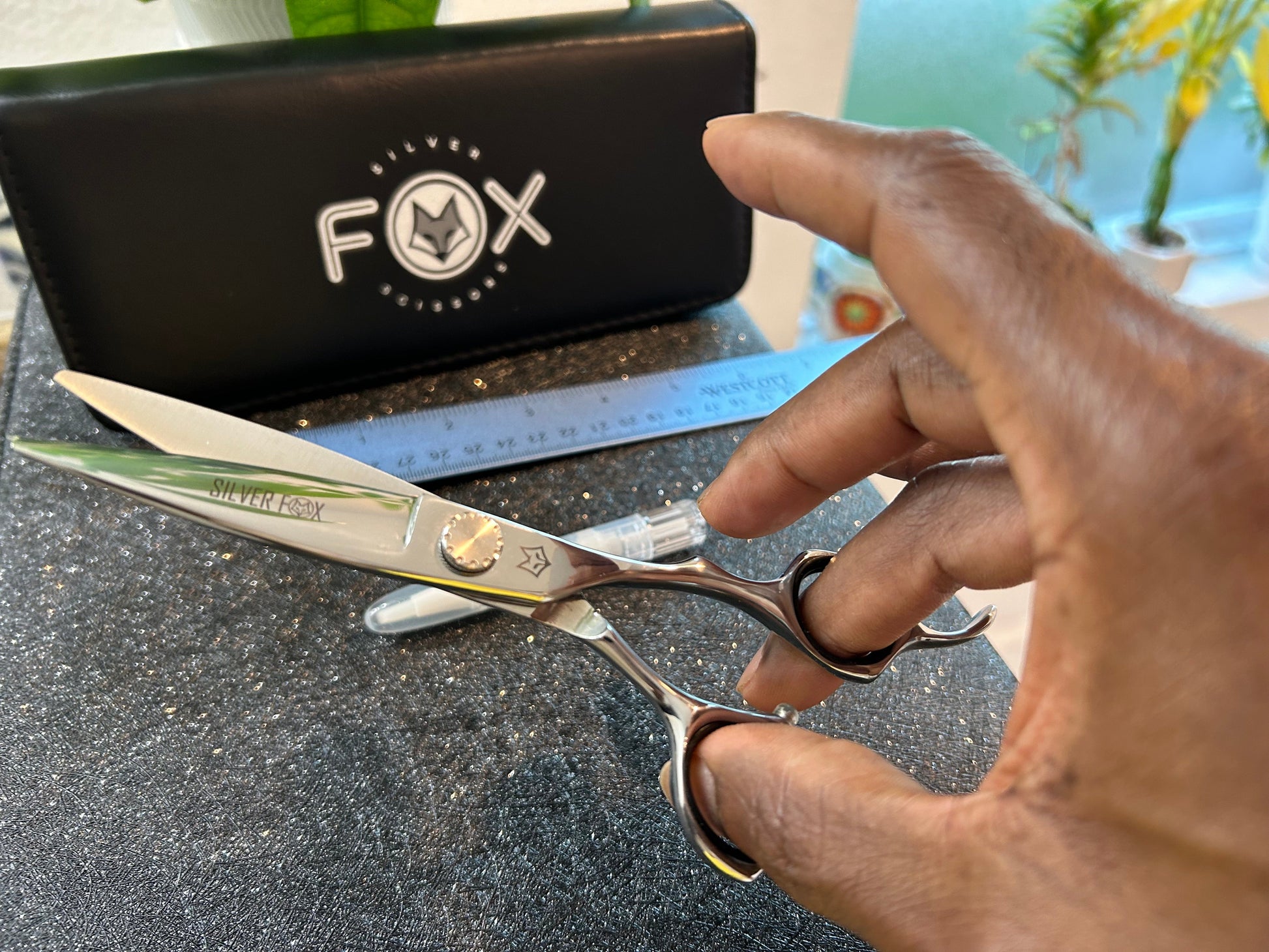 Scissors held with fingers threaded through rings.