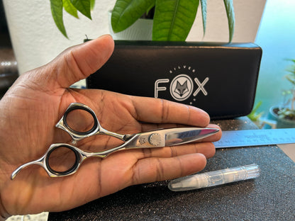 Scissors resting against palm of hand.