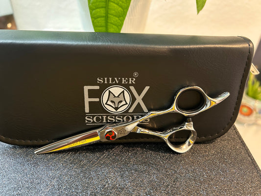 Scissors resting against black case.