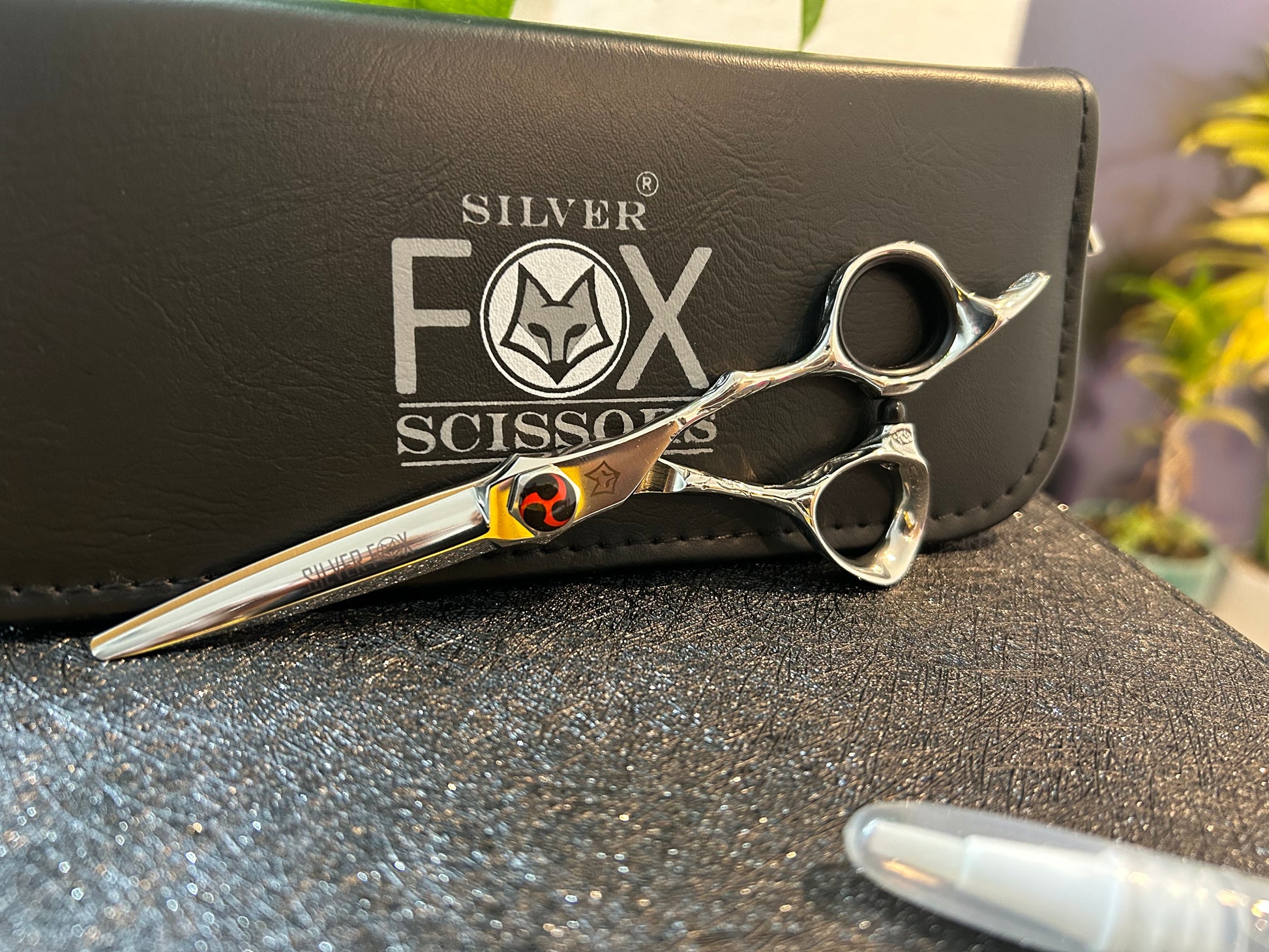 Scissors resting against black case.