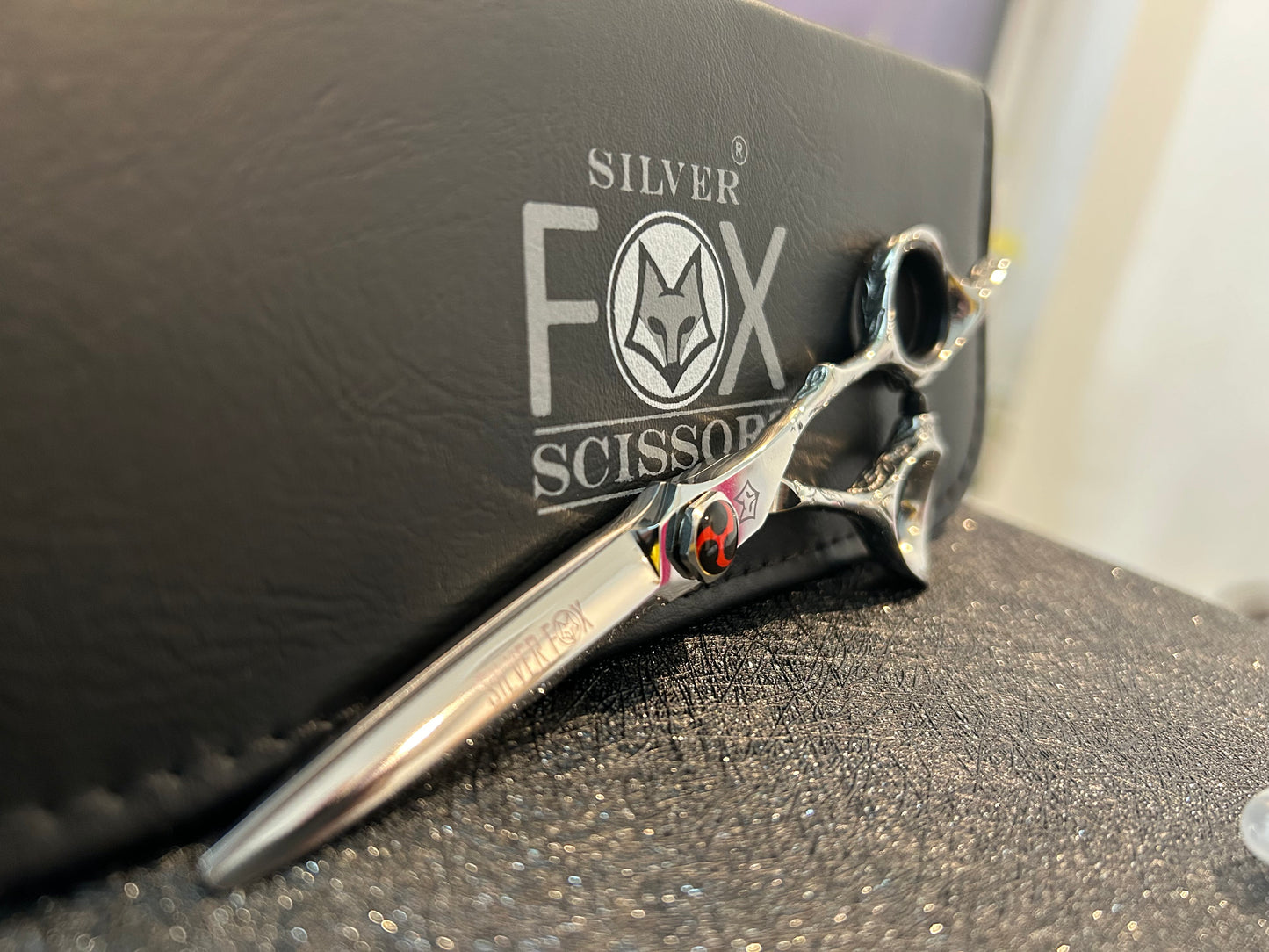 Scissors resting against black case.