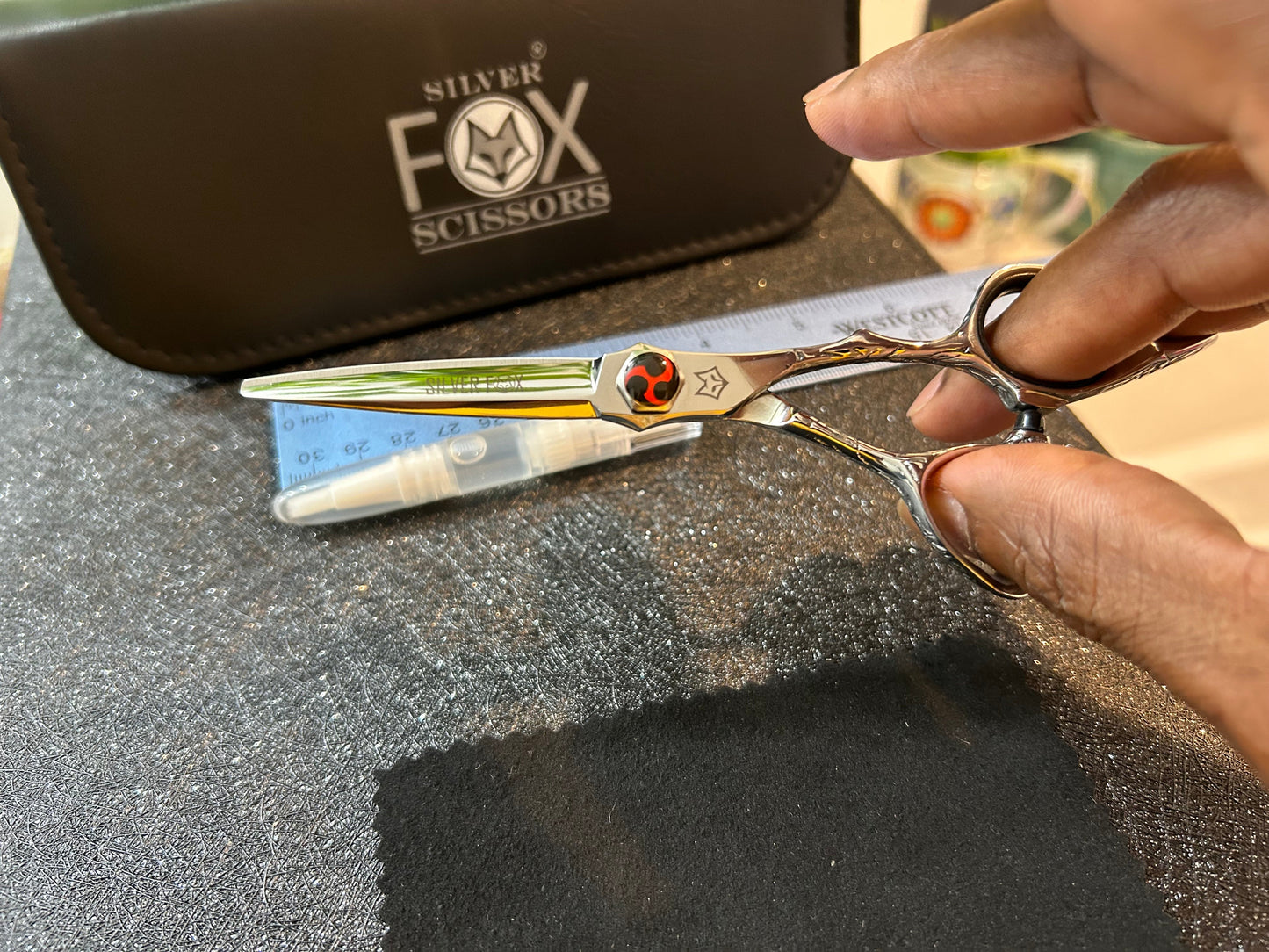 Scissors held with fingers threaded through rings.