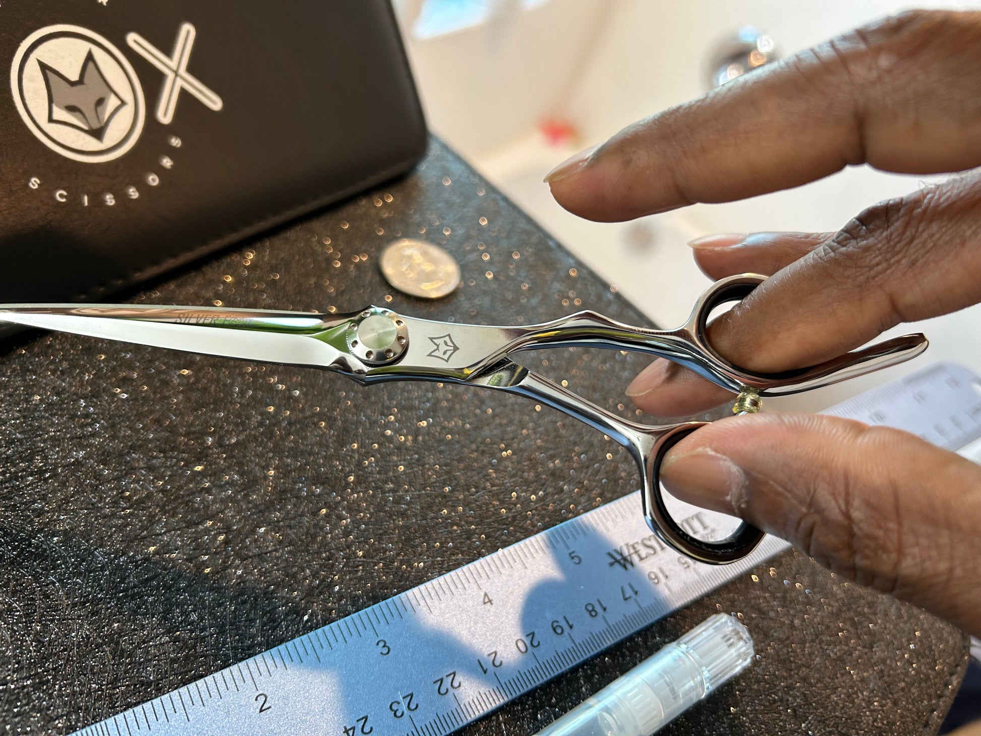 Scissors held with fingers threaded through rings.