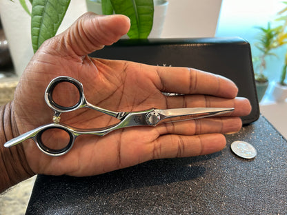 Scissors resting against palm of hand.