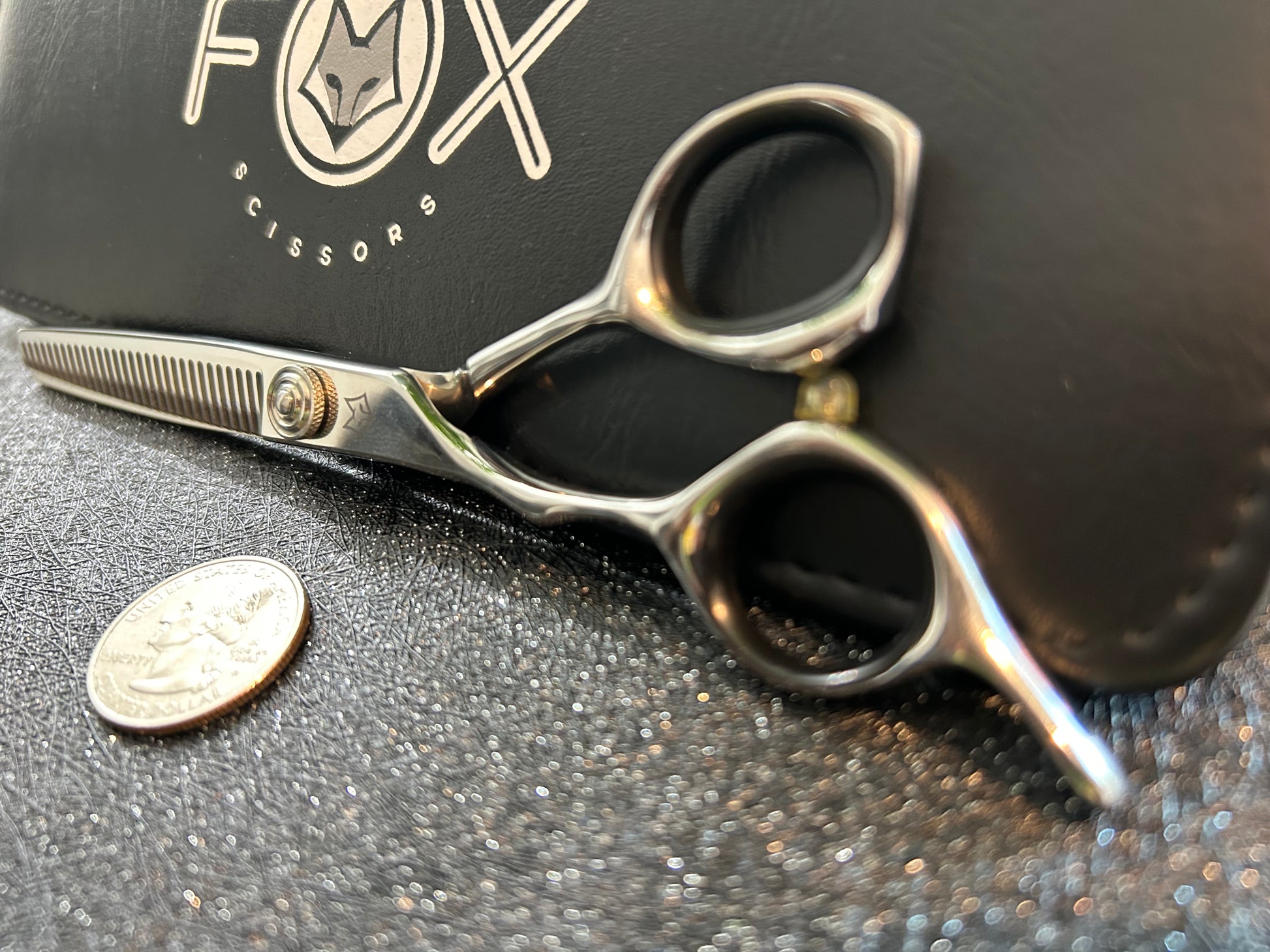 Scissors resting against black case.