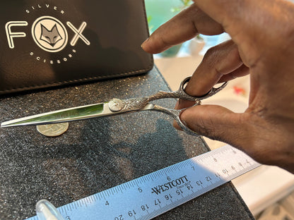 Scissors held with fingers threaded through rings.