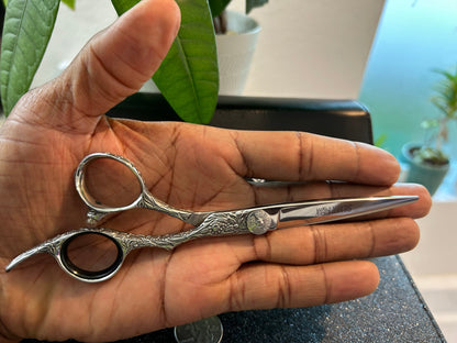 Scissors resting against palm of hand.