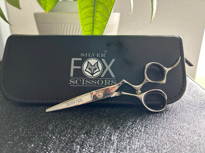 Frontal view of Silver Fox Scissors Model SF28 resting upright on display case.