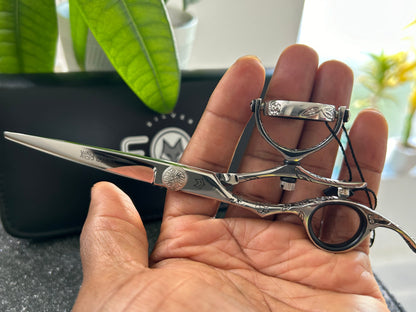 Scissors resting against palm of hand.