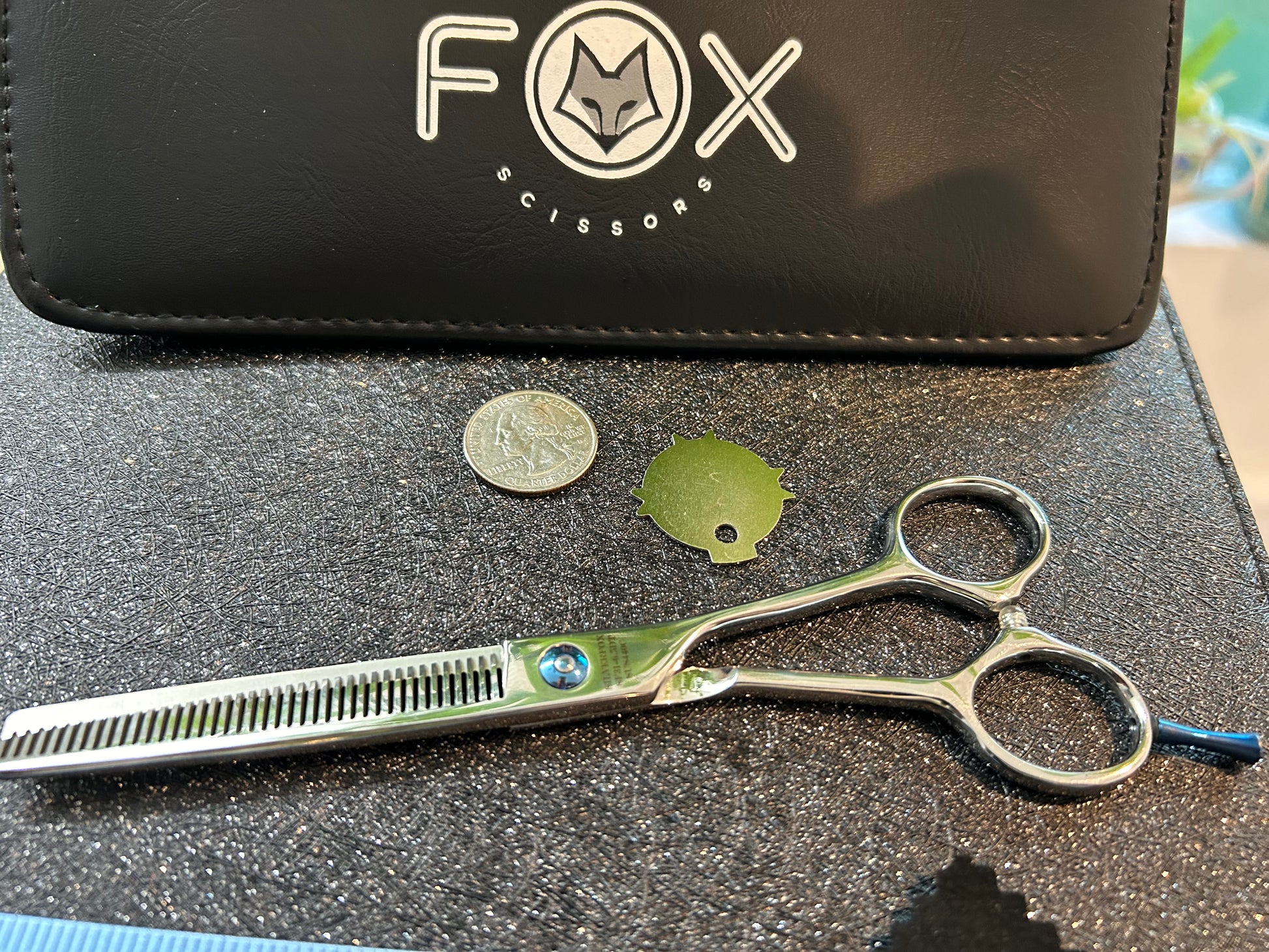 Top view of scissors next to objects for scale.