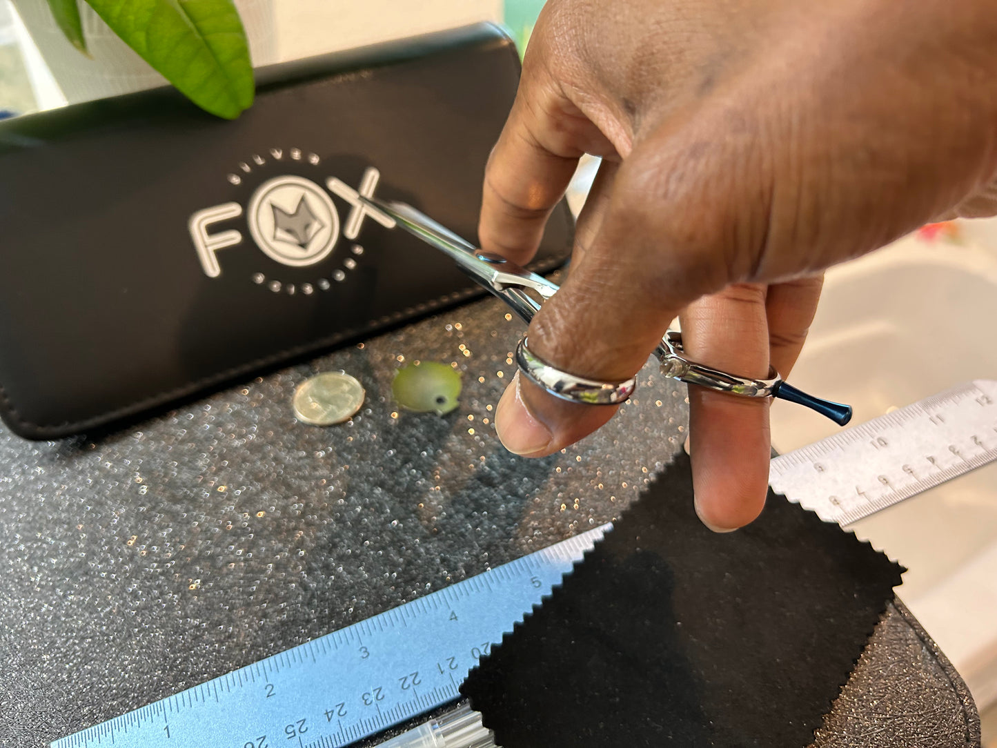 Scissors held with fingers threaded through rings.