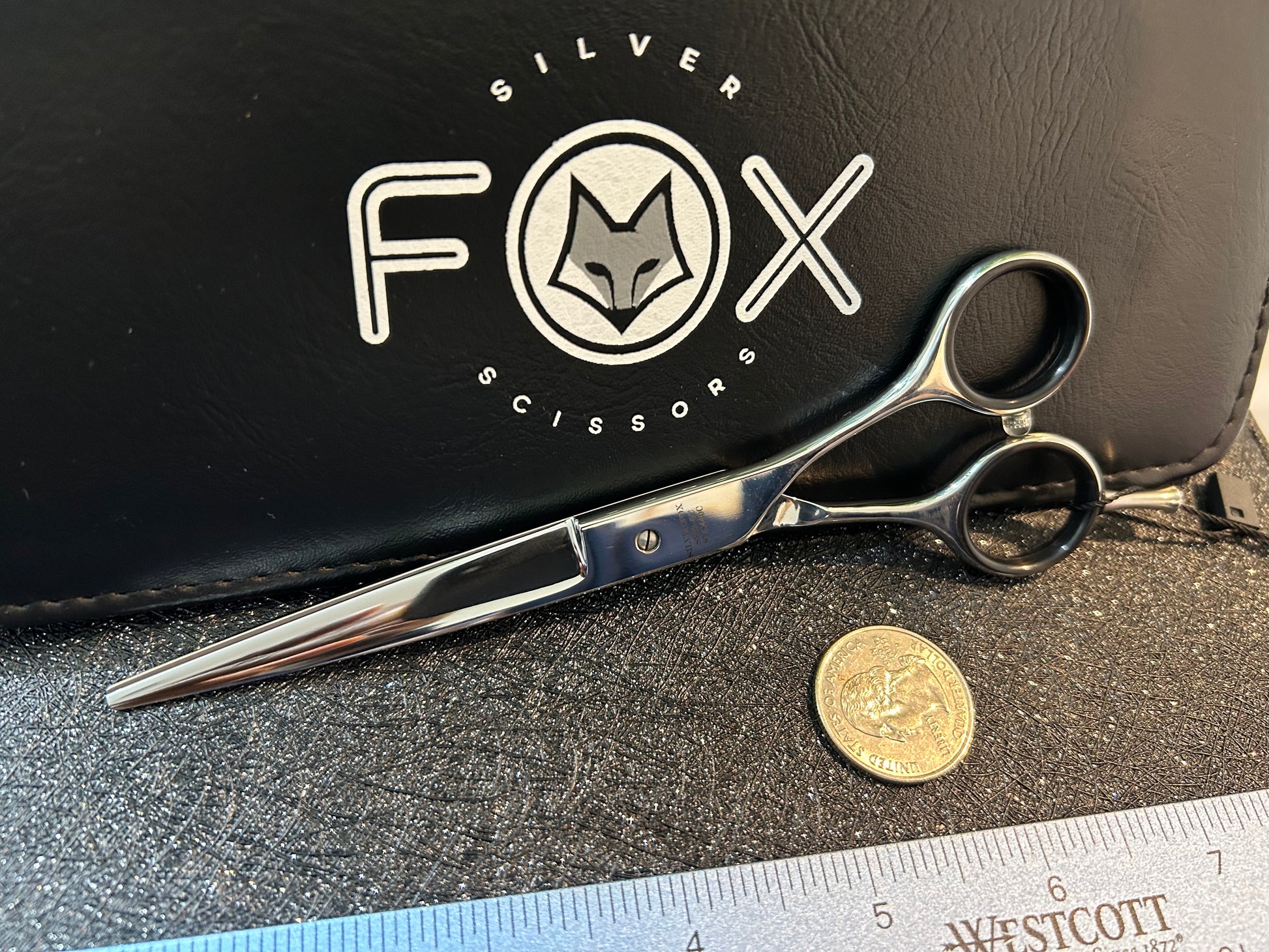 Scissors resting against black case.