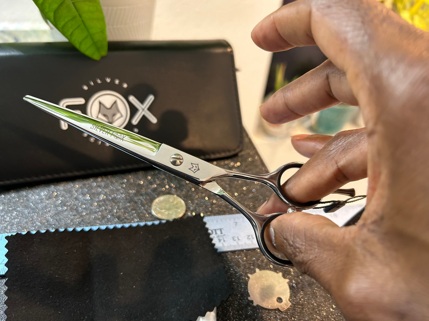 Scissors held with fingers threaded through rings.