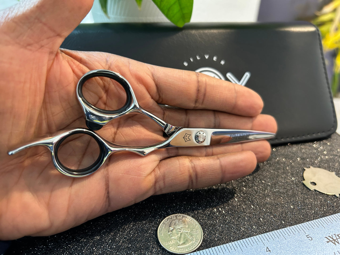 Scissors resting against palm of hand.