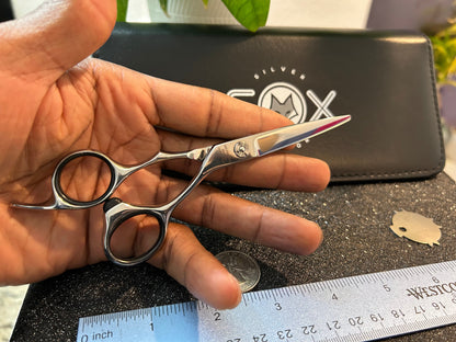 Scissors resting against fingers.