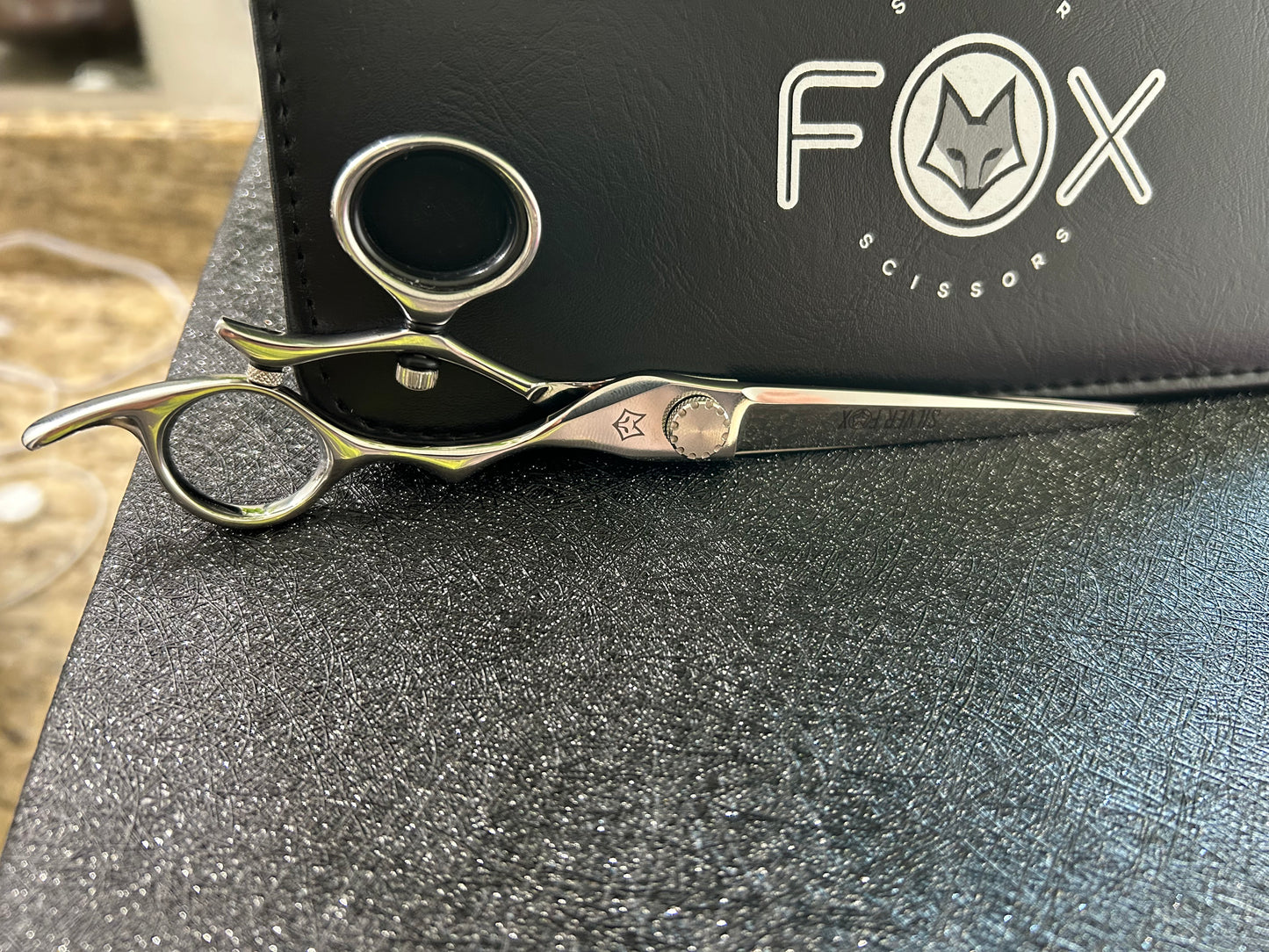 Scissors resting against black case.