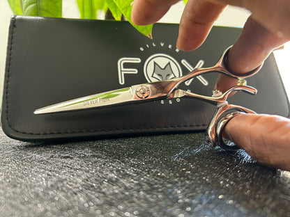 Scissors held with fingers threaded through rings.