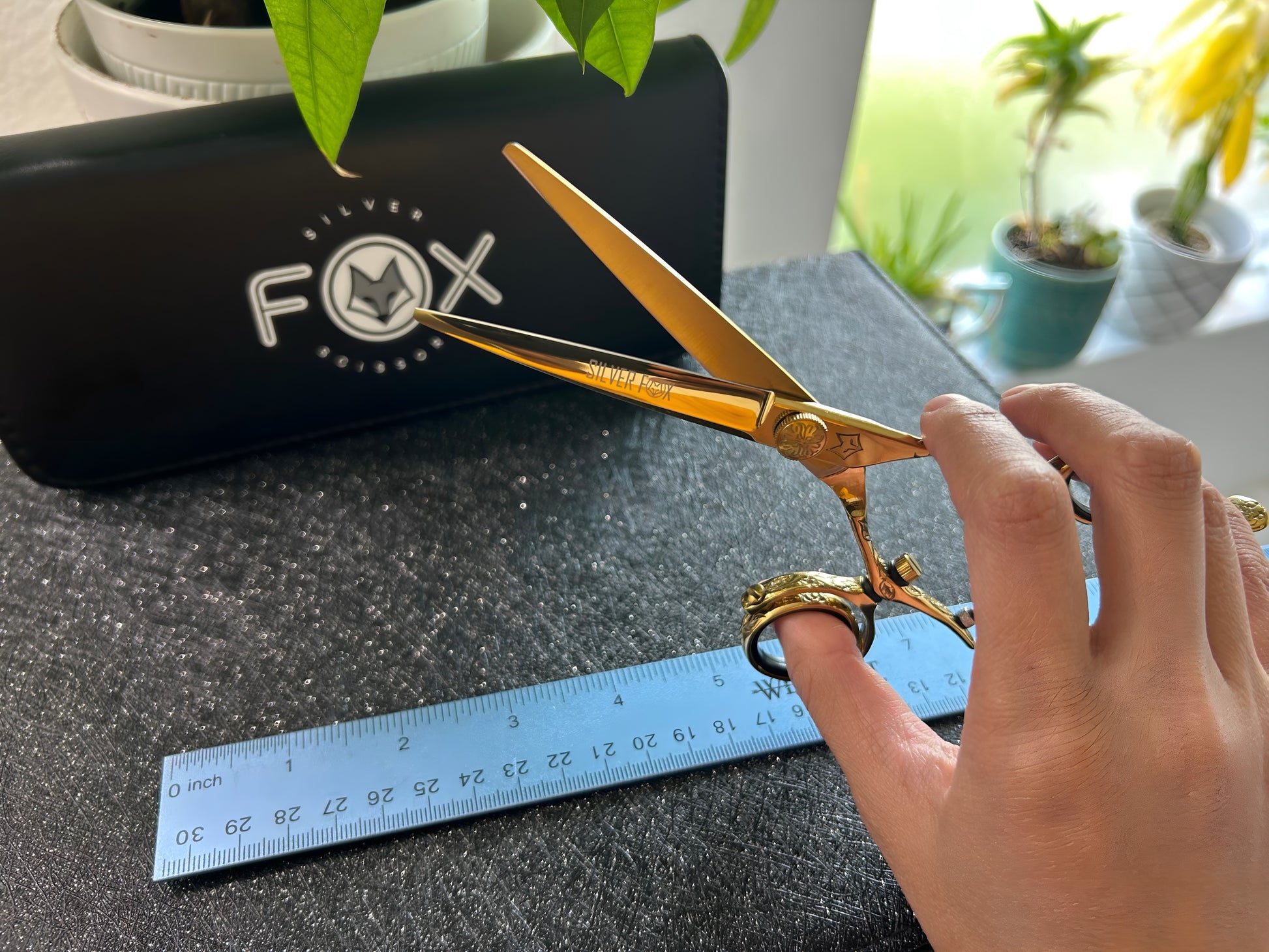 Scissors held with fingers threaded through rings.