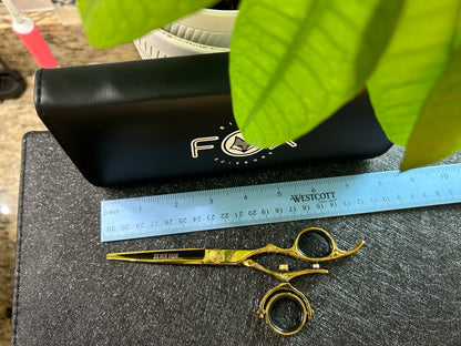 Top view of scissors with ruler for scale.