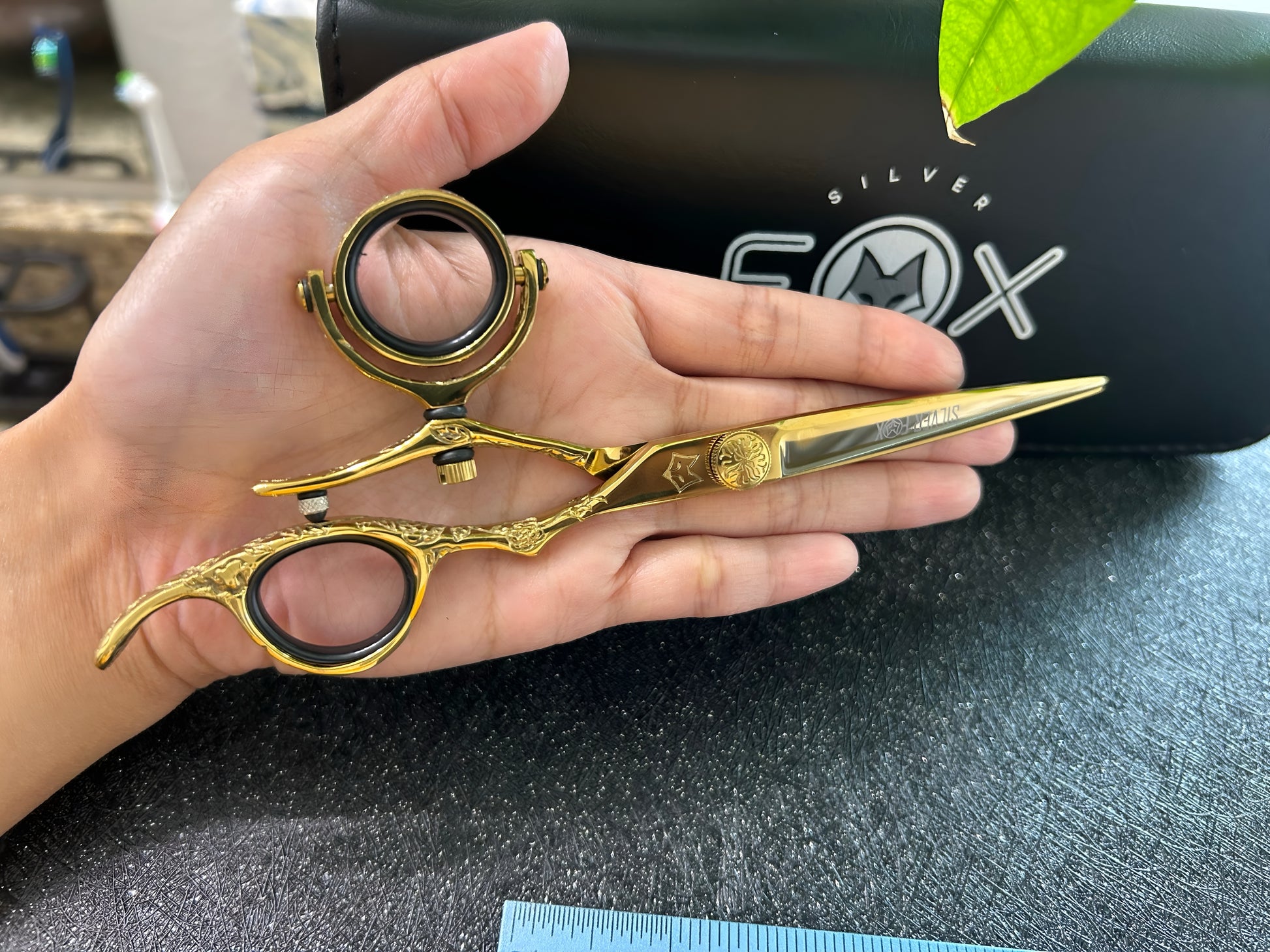 Scissors held in palm of hand.